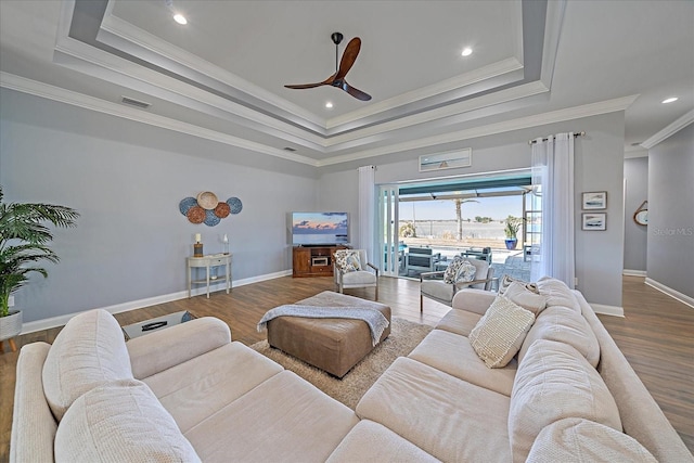 29527 Leah Rd, Punta Gorda, FL 33982 - living area featuring a tray ceiling, ornamental molding, a ceiling fan, wood finished floors, and recessed lighting