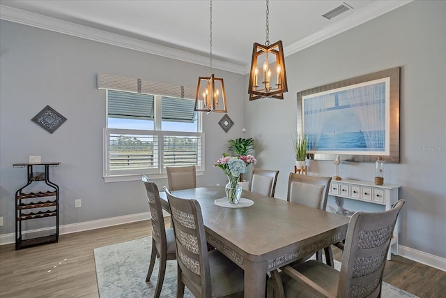29527 Leah Rd, Punta Gorda, FL 33982 - dining area featuring a chandelier, ornamental molding, and wood finished floors