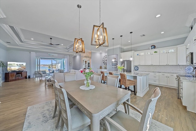 29527 Leah Rd, Punta Gorda, FL 33982 - dining space with crown molding, a ceiling fan, a chandelier, light wood finished floors, and recessed lighting
