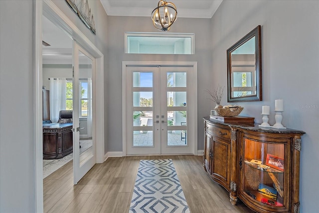 29527 Leah Rd, Punta Gorda, FL 33982 - foyer featuring french doors, a chandelier, light wood-style floors, and ornamental molding