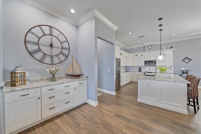 29527 Leah Rd, Punta Gorda, FL 33982 - kitchen featuring stainless steel appliances, ornamental molding, white cabinetry, backsplash, and recessed lighting