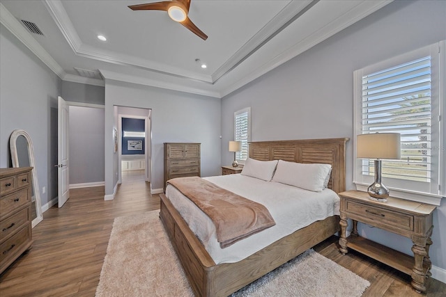 29527 Leah Rd, Punta Gorda, FL 33982 - bedroom featuring a tray ceiling, wood finished floors, ornamental molding, recessed lighting, and a ceiling fan