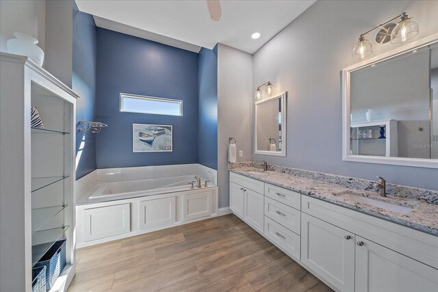 29527 Leah Rd, Punta Gorda, FL 33982 - full bath featuring double vanity, a garden tub, and wood finished floors