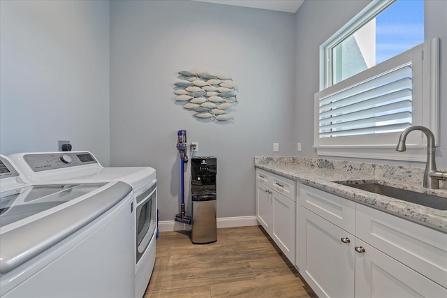 29527 Leah Rd, Punta Gorda, FL 33982 - laundry room with washing machine and dryer, wood finished floors, and cabinet space