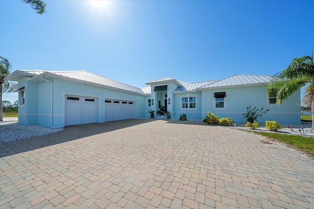 29527 Leah Rd, Punta Gorda, FL 33982 - ranch-style home with a standing seam roof, stucco siding, and decorative driveway