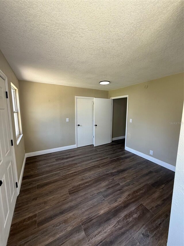 1132 26th Ave S, Saint Petersburg, FL 33705 - unfurnished room with dark wood finished floors and a textured ceiling