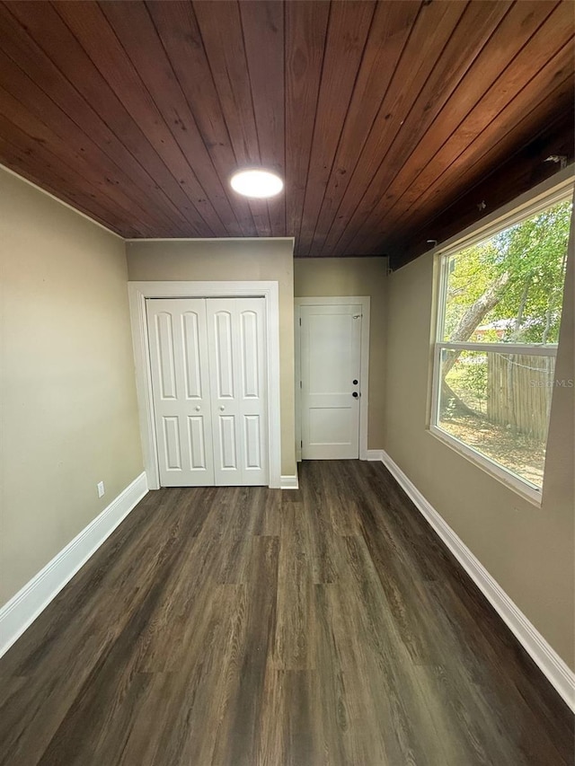 1132 26th Ave S, Saint Petersburg, FL 33705 - unfurnished bedroom featuring dark wood-style floors, wood ceiling, and a closet