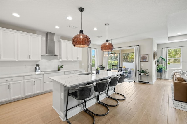 3621 Wild Blossom Pl, Parrish, FL 34219 - kitchen featuring wall chimney exhaust hood, black electric cooktop, healthy amount of natural light, decorative backsplash, and recessed lighting