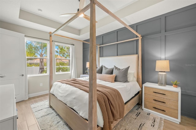 3621 Wild Blossom Pl, Parrish, FL 34219 - bedroom featuring light wood-style floors, ceiling fan, and a tray ceiling