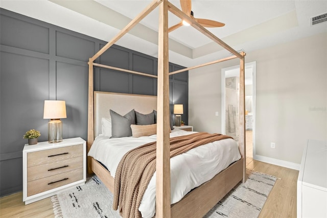 3621 Wild Blossom Pl, Parrish, FL 34219 - bedroom featuring light wood-style floors, a ceiling fan, and ensuite bathroom