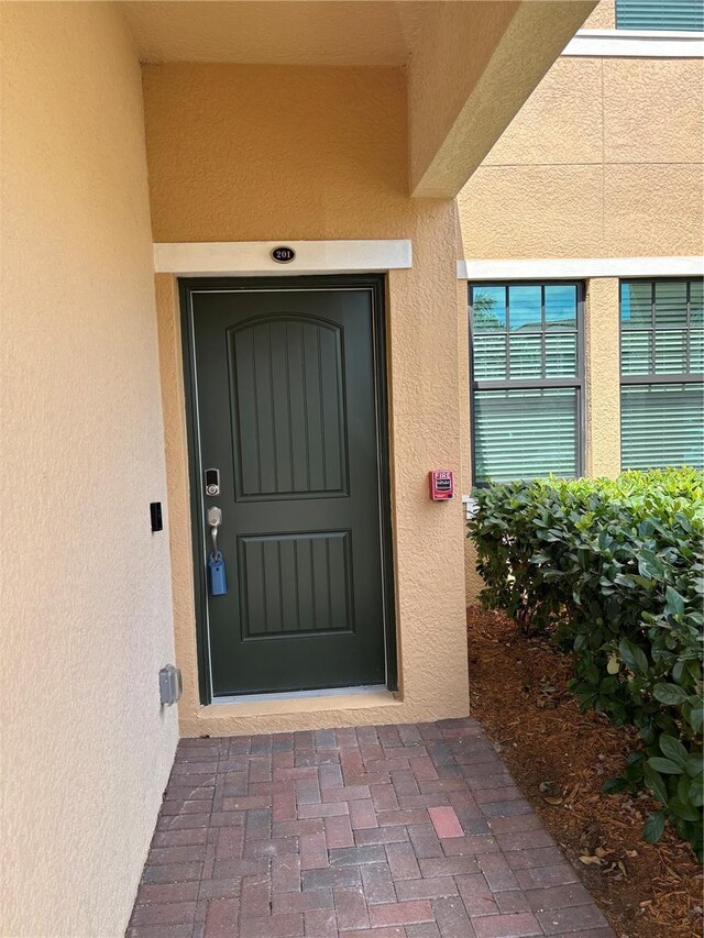 10054 Crooked Creek Dr Unit 201, Venice, FL 34293 - view of exterior entry with stucco siding
