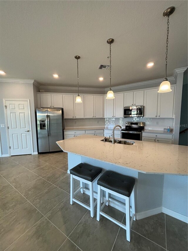 10054 Crooked Creek Dr Unit 201, Venice, FL 34293 - kitchen with stainless steel appliances, ornamental molding, decorative backsplash, white cabinetry, and decorative light fixtures