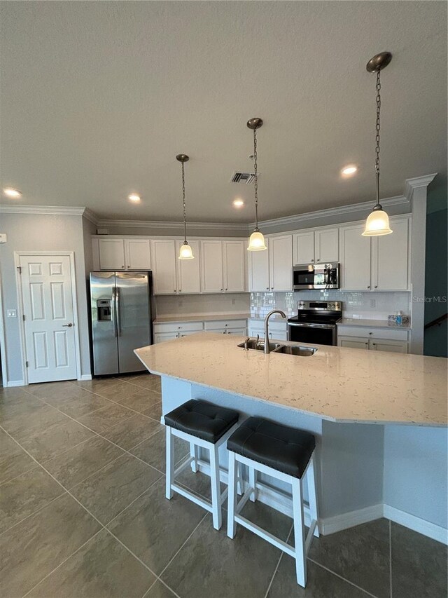 10054 Crooked Creek Dr Unit 201, Venice, FL 34293 - kitchen with stainless steel appliances, ornamental molding, white cabinets, decorative backsplash, and light stone countertops