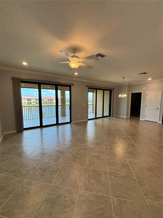 10054 Crooked Creek Dr Unit 201, Venice, FL 34293 - tiled spare room featuring ornamental molding, a textured ceiling, recessed lighting, a ceiling fan, and a chandelier