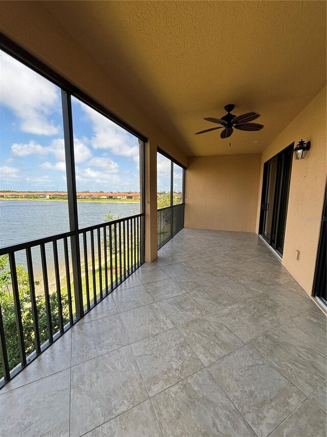 10054 Crooked Creek Dr Unit 201, Venice, FL 34293 - unfurnished sunroom featuring a water view and a textured ceiling