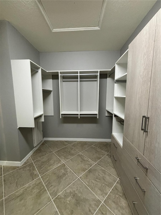 10054 Crooked Creek Dr Unit 201, Venice, FL 34293 - spacious closet featuring dark tile patterned floors