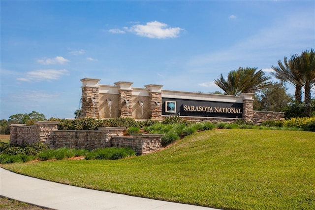 10054 Crooked Creek Dr Unit 201, Venice, FL 34293 - community sign with a lawn