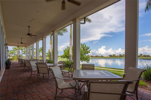 10054 Crooked Creek Dr Unit 201, Venice, FL 34293 - view of patio with outdoor dining space, a ceiling fan, and a water view