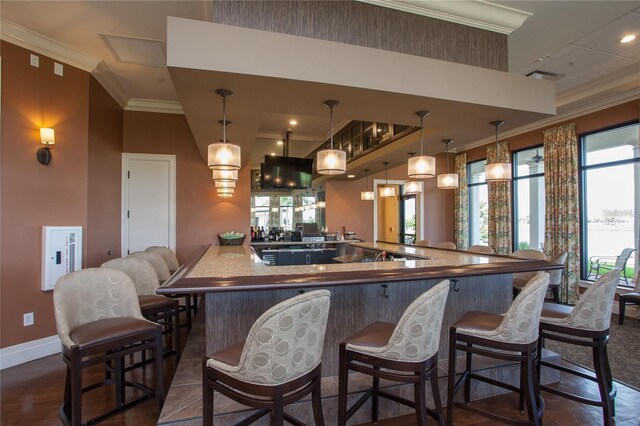 10054 Crooked Creek Dr Unit 201, Venice, FL 34293 - kitchen featuring crown molding, a kitchen breakfast bar, a large island, and hanging light fixtures
