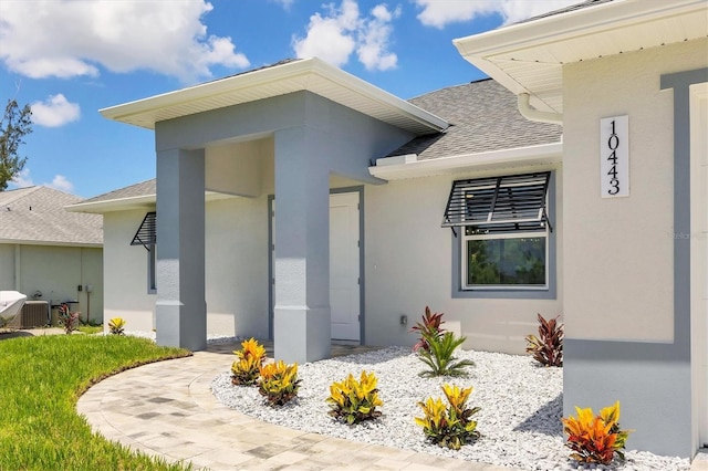 10443 Riverside Rd, Port Charlotte, FL 33981 - property entrance with a shingled roof and stucco siding