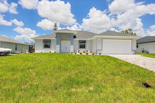 10443 Riverside Rd, Port Charlotte, FL 33981 - prairie-style house featuring stucco siding, a garage, decorative driveway, a front lawn, and roof with shingles