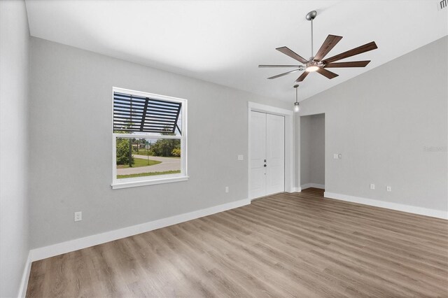 10443 Riverside Rd, Port Charlotte, FL 33981 - unfurnished room featuring wood finished floors, vaulted ceiling, and a ceiling fan