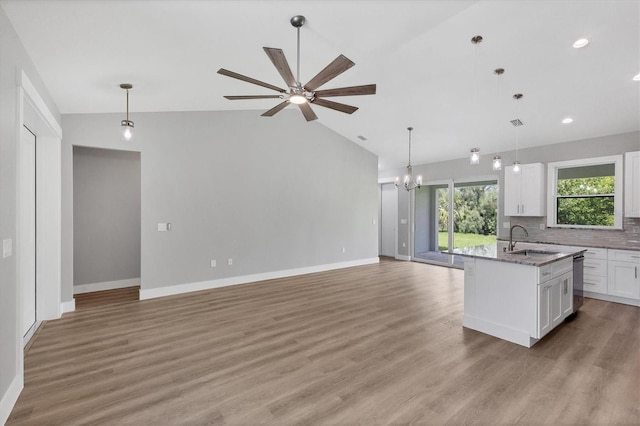 10443 Riverside Rd, Port Charlotte, FL 33981 - kitchen with open floor plan, dishwasher, white cabinetry, a chandelier, and vaulted ceiling