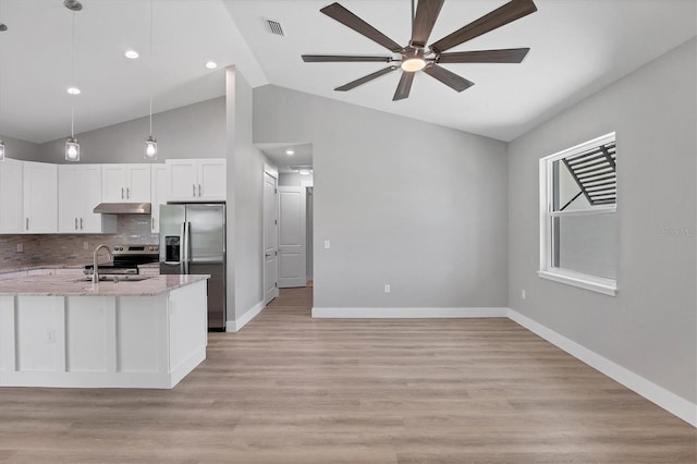 10443 Riverside Rd, Port Charlotte, FL 33981 - kitchen featuring appliances with stainless steel finishes, a ceiling fan, backsplash, light stone counters, and white cabinets