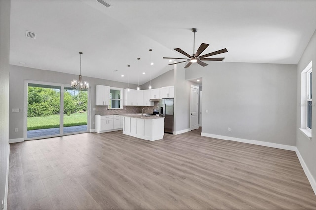 10443 Riverside Rd, Port Charlotte, FL 33981 - unfurnished living room with a chandelier, light wood-style flooring, ceiling fan, high vaulted ceiling, and recessed lighting