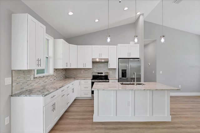 10443 Riverside Rd, Port Charlotte, FL 33981 - kitchen with appliances with stainless steel finishes, white cabinets, tasteful backsplash, light stone counters, and light wood finished floors
