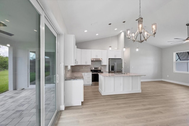 10443 Riverside Rd, Port Charlotte, FL 33981 - kitchen with appliances with stainless steel finishes, a ceiling fan, open floor plan, under cabinet range hood, and white cabinetry