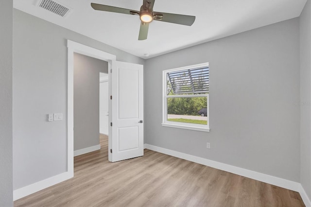 10443 Riverside Rd, Port Charlotte, FL 33981 - unfurnished bedroom with light wood finished floors and ceiling fan