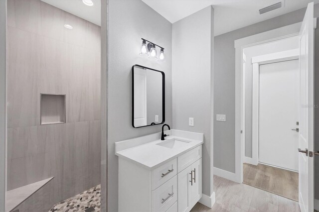 10443 Riverside Rd, Port Charlotte, FL 33981 - bathroom with vanity, walk in shower, and wood finished floors