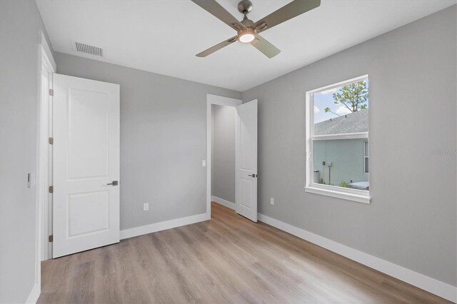 10443 Riverside Rd, Port Charlotte, FL 33981 - unfurnished bedroom with wood finished floors and a ceiling fan