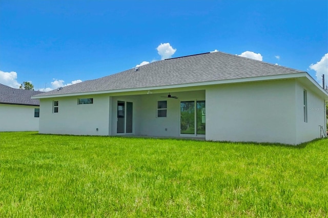 10443 Riverside Rd, Port Charlotte, FL 33981 - back of house featuring a ceiling fan, stucco siding, and a yard