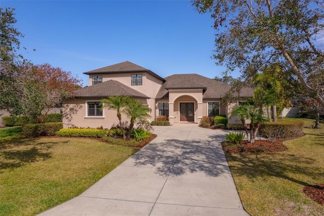 14901 17th Ave E, Bradenton, FL 34212 - traditional-style home with stucco siding, french doors, a front lawn, and driveway