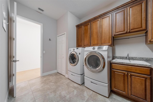14901 17th Ave E, Bradenton, FL 34212 - washroom with independent washer and dryer, cabinet space, and light tile patterned flooring