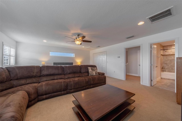 14901 17th Ave E, Bradenton, FL 34212 - living room with light colored carpet, plenty of natural light, a ceiling fan, recessed lighting, and a textured ceiling
