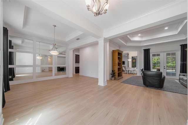 14901 17th Ave E, Bradenton, FL 34212 - living room with a raised ceiling, french doors, light wood-style floors, decorative columns, and ornamental molding