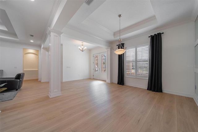 14901 17th Ave E, Bradenton, FL 34212 - unfurnished living room featuring decorative columns, a raised ceiling, light wood-style flooring, a chandelier, and ornamental molding