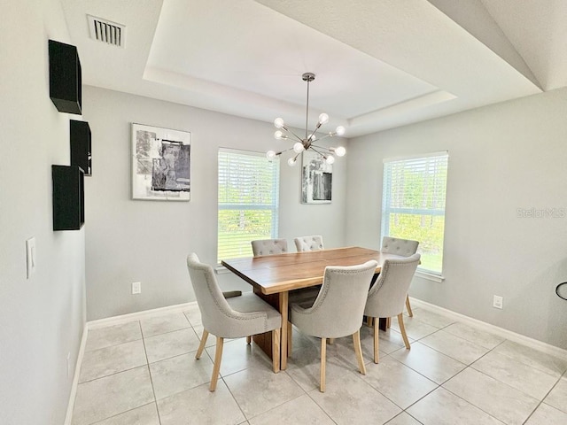 2425 Maclachlan St, Port Charlotte, FL 33953 - dining space featuring healthy amount of natural light, a tray ceiling, a chandelier, and light tile patterned floors