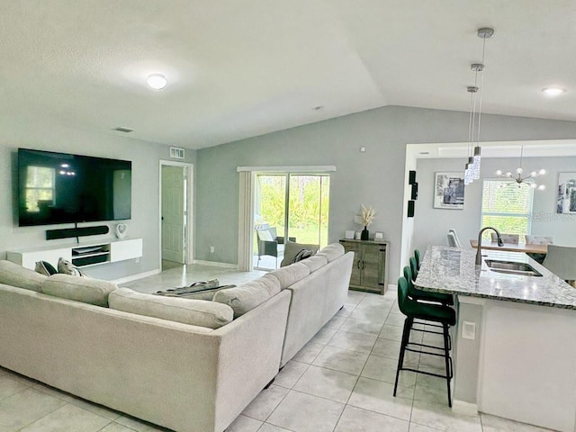 2425 Maclachlan St, Port Charlotte, FL 33953 - living area with lofted ceiling, healthy amount of natural light, light tile patterned floors, and a chandelier