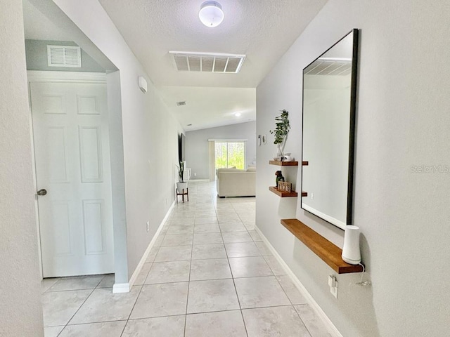 2425 Maclachlan St, Port Charlotte, FL 33953 - hall with light tile patterned floors, lofted ceiling, and a textured ceiling