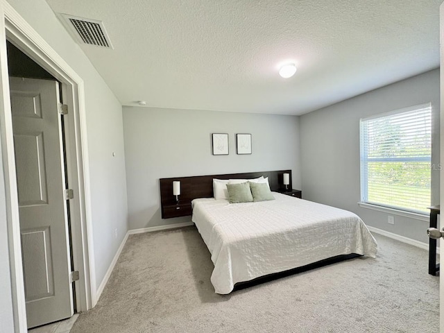2425 Maclachlan St, Port Charlotte, FL 33953 - bedroom with light colored carpet and a textured ceiling