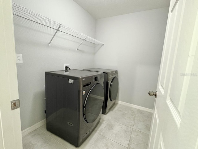 2425 Maclachlan St, Port Charlotte, FL 33953 - laundry area featuring washer and dryer and light tile patterned floors