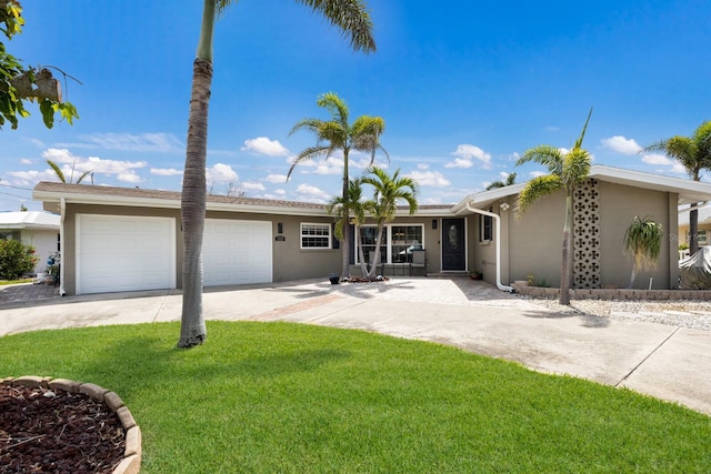 3715 101st St W, Bradenton, FL 34210 - single story home with an attached garage, concrete driveway, a front yard, and stucco siding