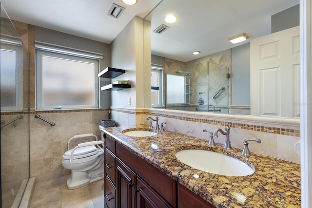3715 101st St W, Bradenton, FL 34210 - bathroom with tile walls, a tile shower, tile patterned floors, double vanity, and wainscoting