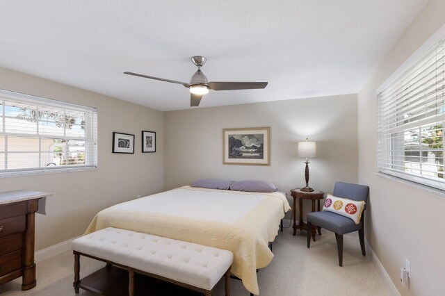 3715 101st St W, Bradenton, FL 34210 - bedroom with light colored carpet, multiple windows, and a ceiling fan