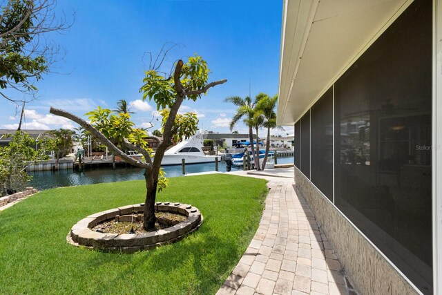 3715 101st St W, Bradenton, FL 34210 - view of grassy yard featuring a water view, a sunroom, and a boat dock