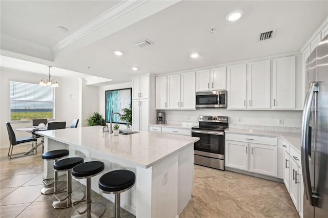 850 Tidewater Shores Loop Unit 102, Bradenton, FL 34208 - kitchen with stainless steel appliances, ornamental molding, a chandelier, white cabinets, and recessed lighting